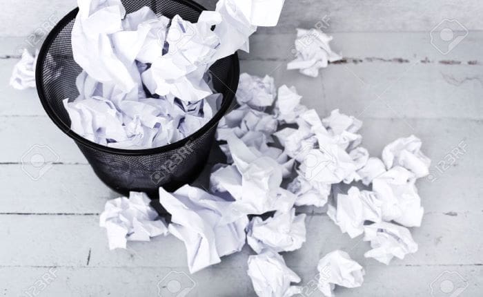 crumpled paper in a trashcan
